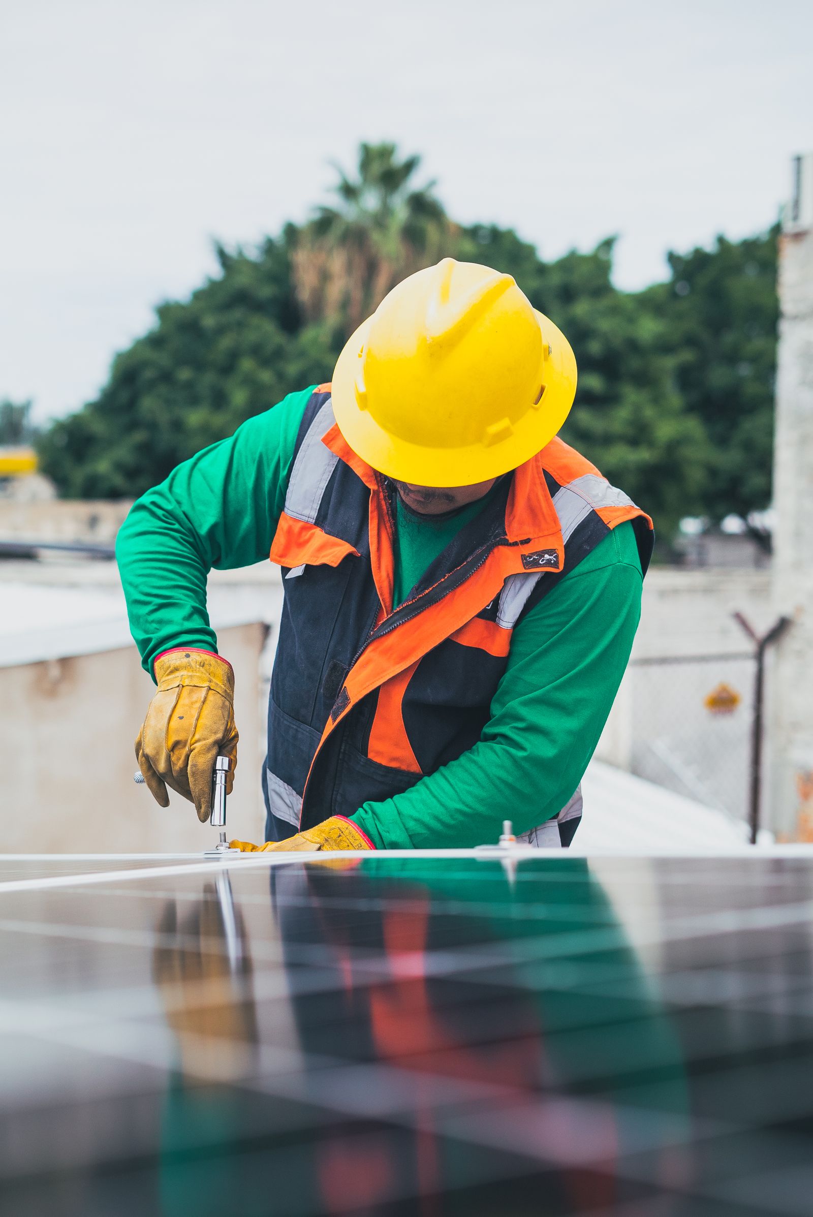 Solar field technician installing equipment outdoors