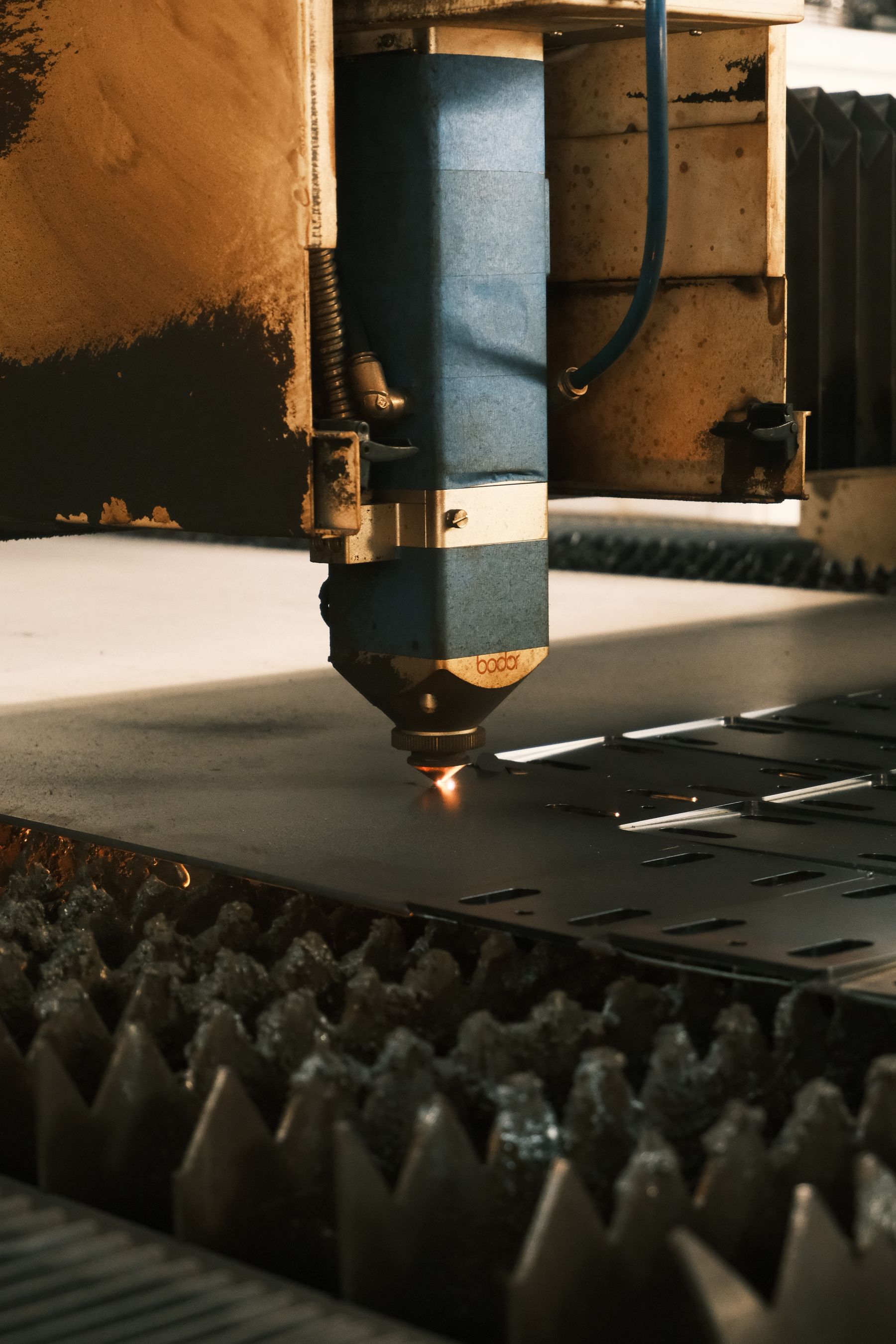 Industrial laser cutter shaping sheet metal